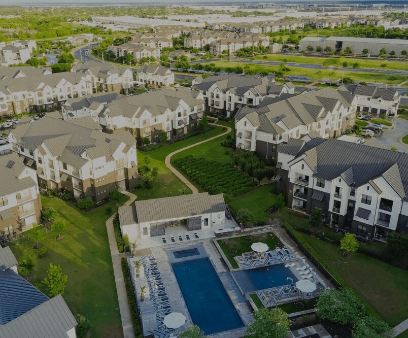 Aerial view of residential complex with pool.